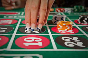 Placing Casino Chips on Roulette Table Number 