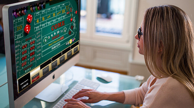 Woman Playing Online Craps Game on Computer