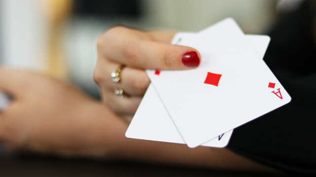 Woman Holding Out to Ace Poker Cards