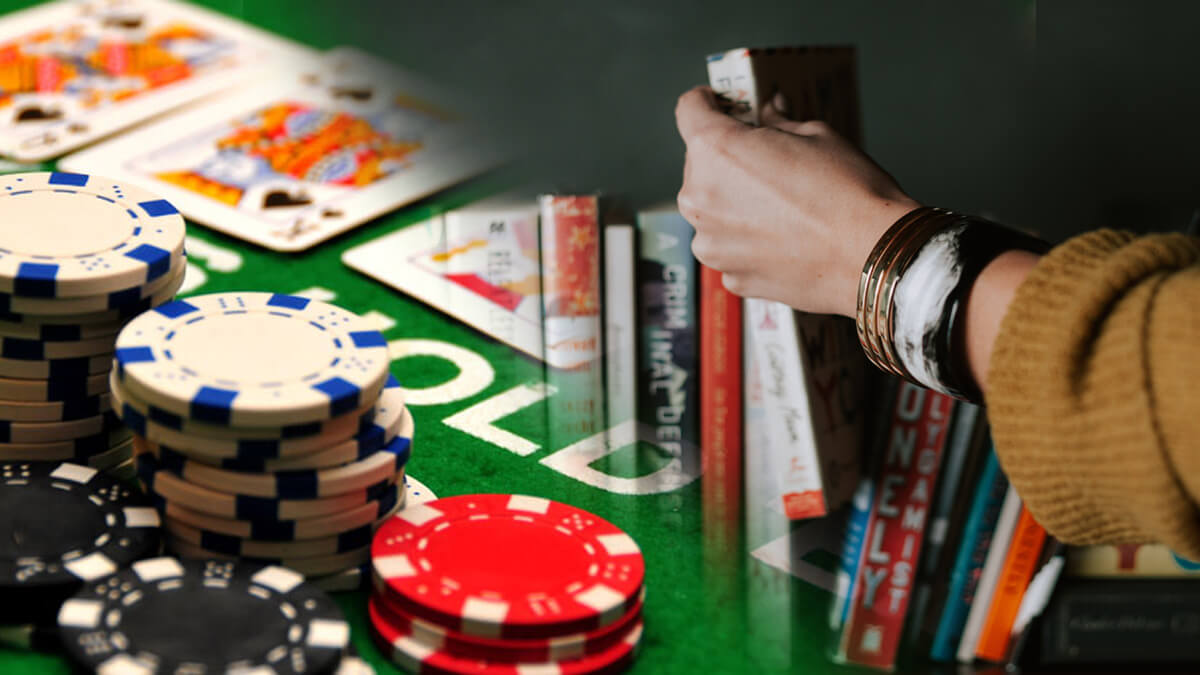 Poker Chips and Cards on Texas Holdem Table, Hand Reaching for Books