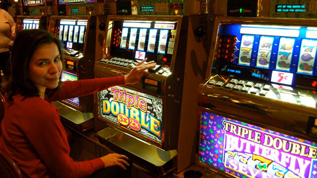 Woman Sitting Playing Casino Slot Machine