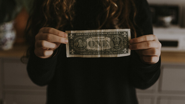 Woman Holding Dollar Bill