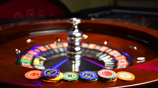 Roulette Wheel With Stacks of Chips in Front