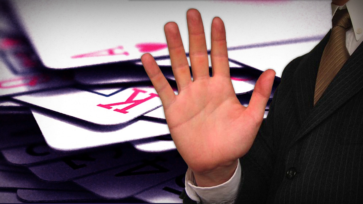 Man in Suit Holding Hand Palm out With a Background of Cards