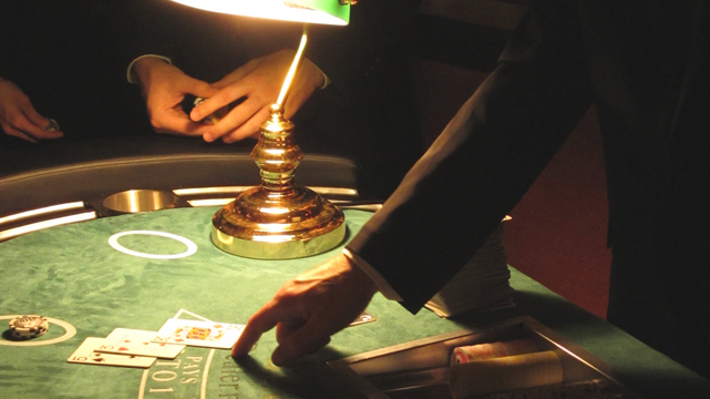 Blackjack Dealer Pointing to Blackjack Hand