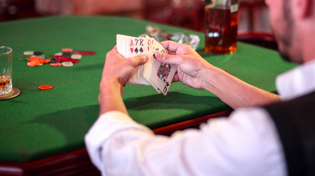 Closeup of Man Sifting Through Deck of Cards