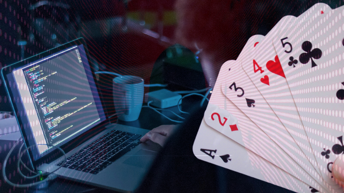 Person Coding on a Laptop and Playing Cards Image