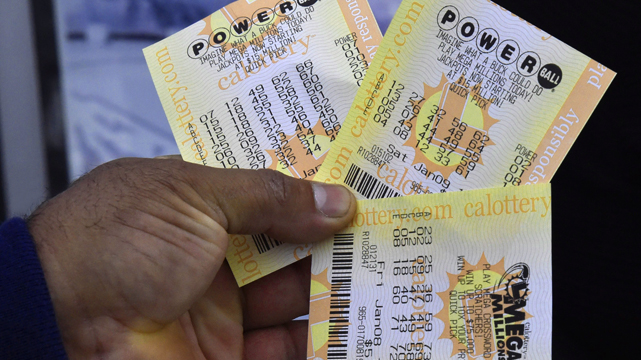 Person Holding Powerball and MegaMillions Lottery Tickets