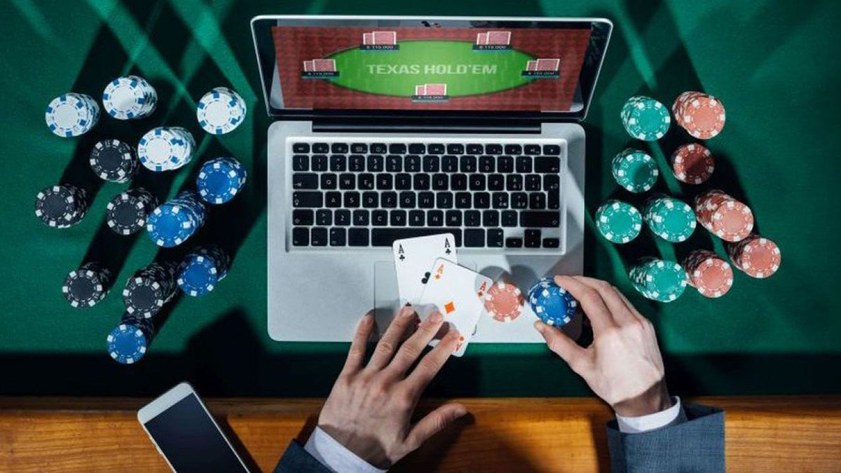 Man Sitting at a Casino Table While Playing Online Poker